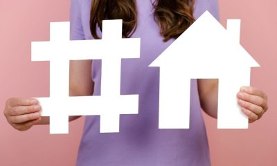 closeup-unrecognizable-woman-holds-white-hashtag-sign-house-model-label-business-marketing-advertising-isolated-pink-wall-social-network-monitoring-media-measurement-mortgage-1024x683-1