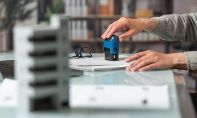 female-hand-puts-stamp-real-estate-deal-1024x683-1